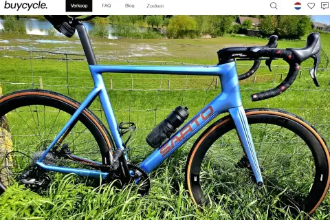 Blauwe racefiets met carbon wielen, klaar om te verkopen. Ideaal om online een racefiets te kopen voor je volgende rit.