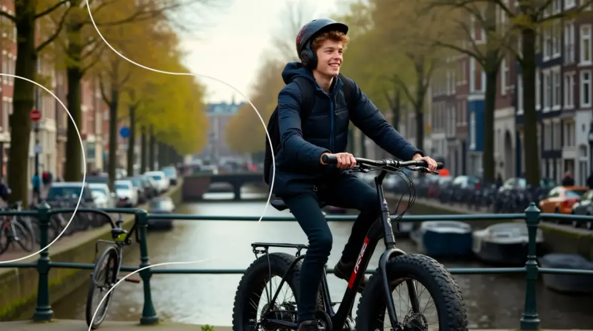 Young man with headphones and helmet rides a fat-tire electric bike along a canal in Amsterdam.